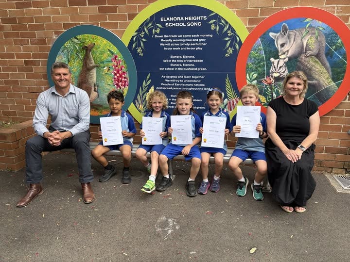Students seated with certificates