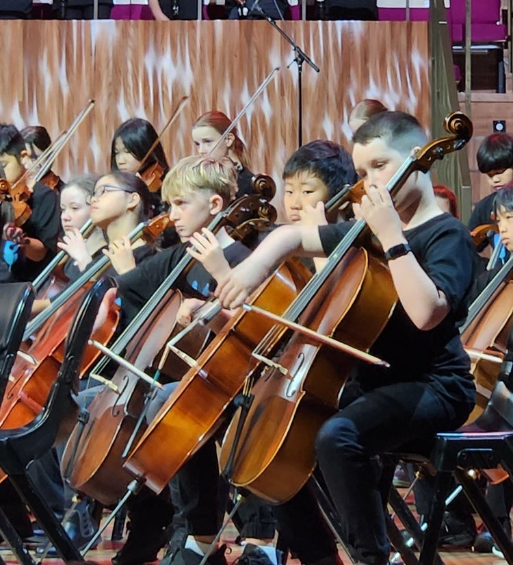 Students playing cellos at Opera House