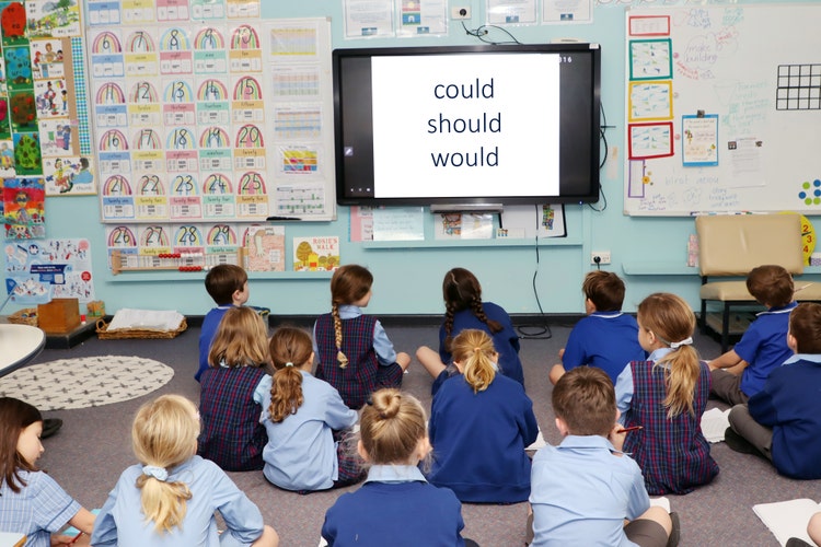 Students seated in fromnt of smart board