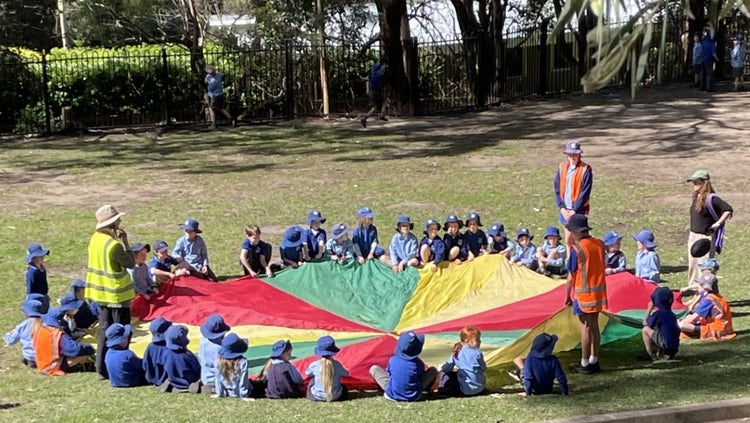 Students playing with tarpaulin